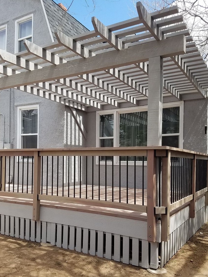 Composite deck with a pergola stained to match the house.