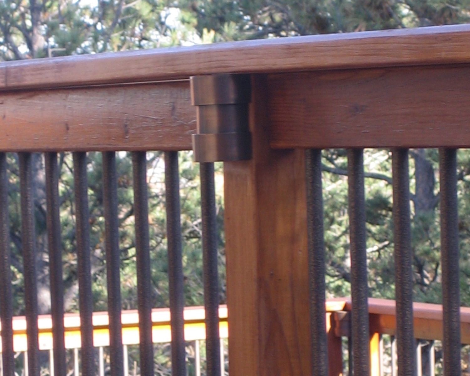 Railing post light installed under the railing drink cap.