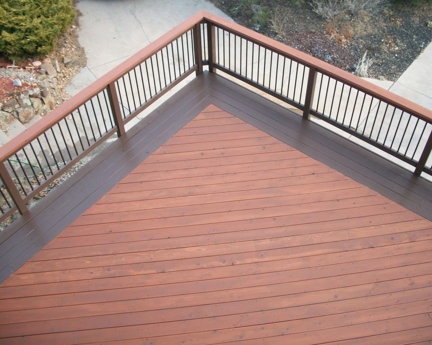 Redwood decking at a 45-degree angle with a four-board picture frame border stained in a contrasting color