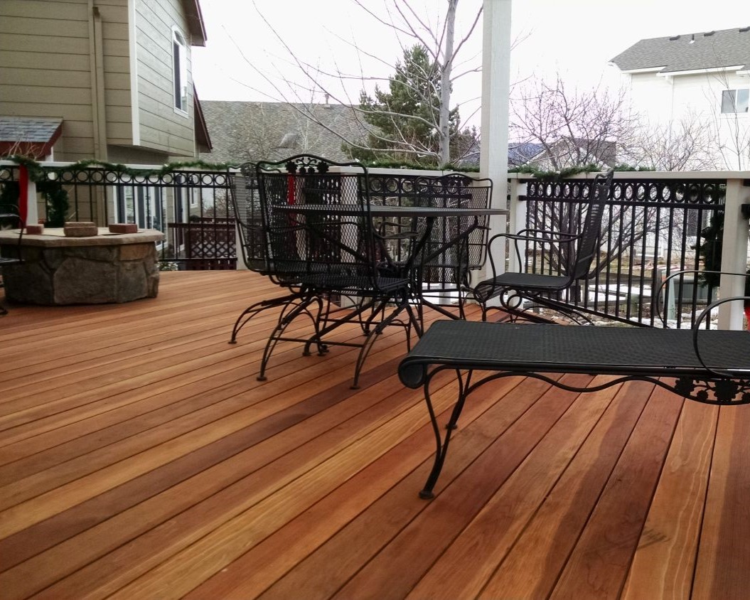 Redwood deck with the boards laid at 45-degrees, a wood and metal railing with a ringtop accent panel. We also added a stone firepit for the homeowners.