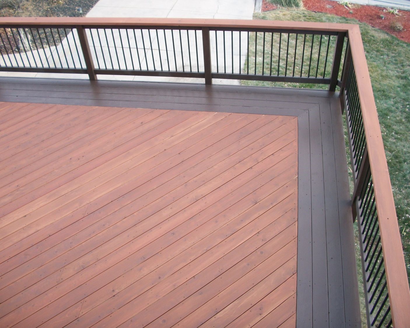 A redwood deck with the boards laid at 45-degree angle to the joists. It also has a quadruple picture frame border stained in a contrasting color.