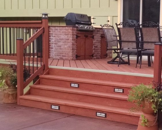 Custom designed Redwood that features a bricked in cooking area and steplights on the wide deck stairs.
