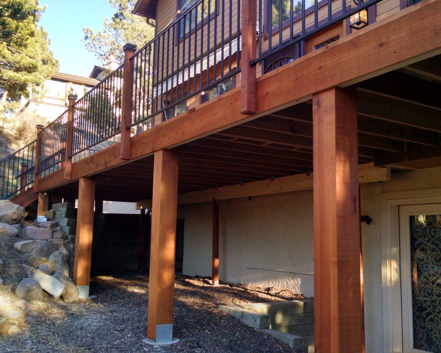 Redwood deck with fascia mounted posts for the metal panel railing.