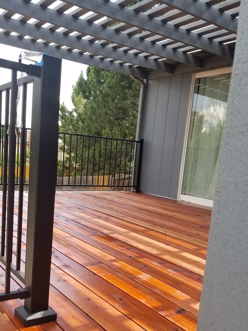 A gorgeous Redwood deck with a pergola stained to match the house.