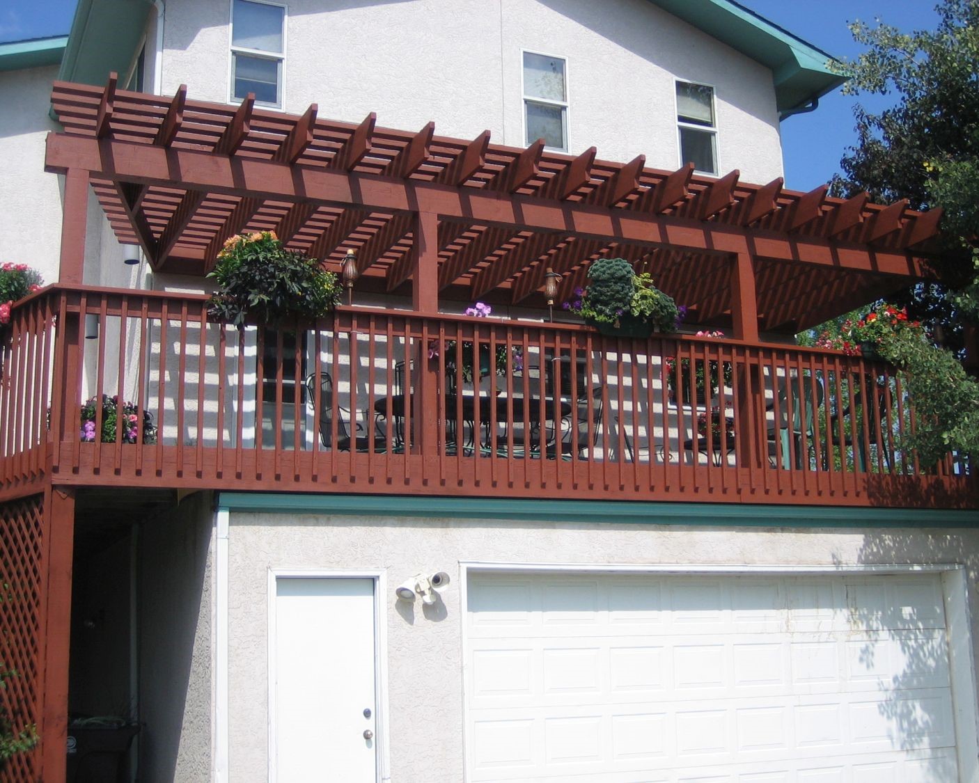 A redwood deck and pergola are built above the home's garage.