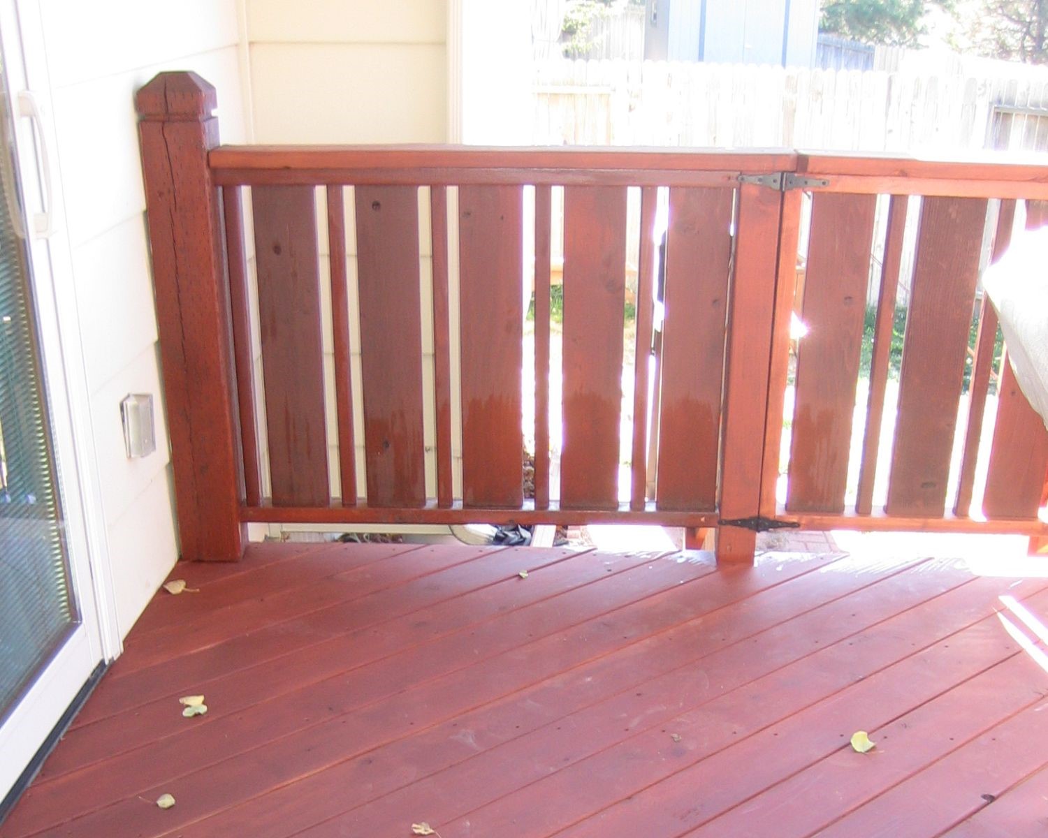 Redwood snow fence deck railing with a panel / baluster design and a matching gate for safety.