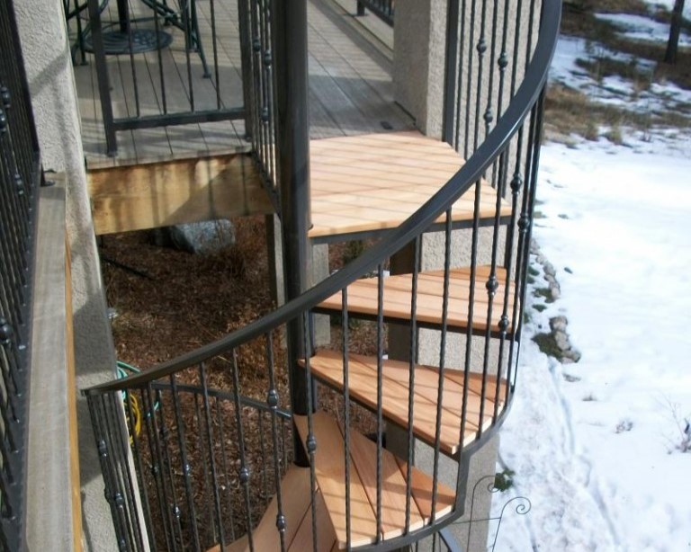 Custom-designed wrought iron spiral staircase with Cumaru hardwood treads.