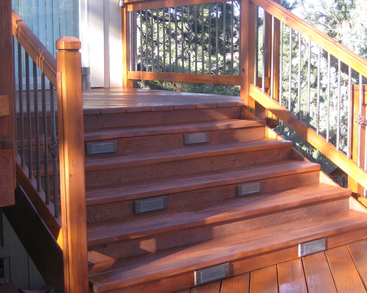 6' wide redwood deck stairs with two Yellow Stone brick lights installed on every other stair riser.