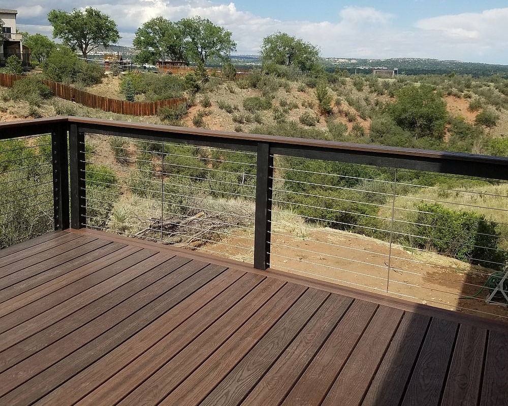 Composite deck with with composite railing and horizontal steel cables.