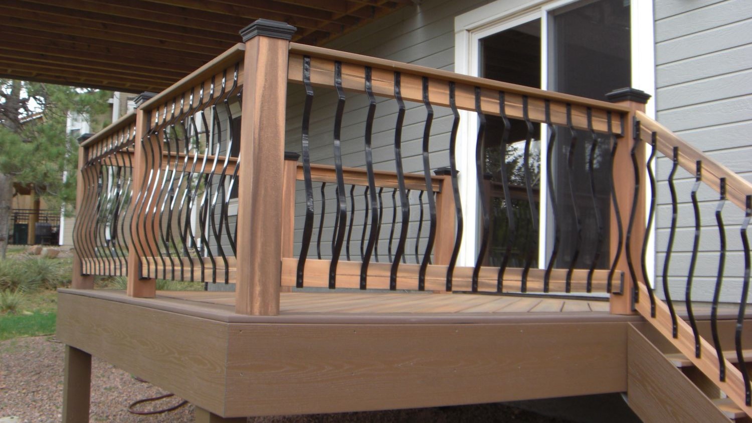 Composite component deck railing with metal Vienna Belly style balusters.