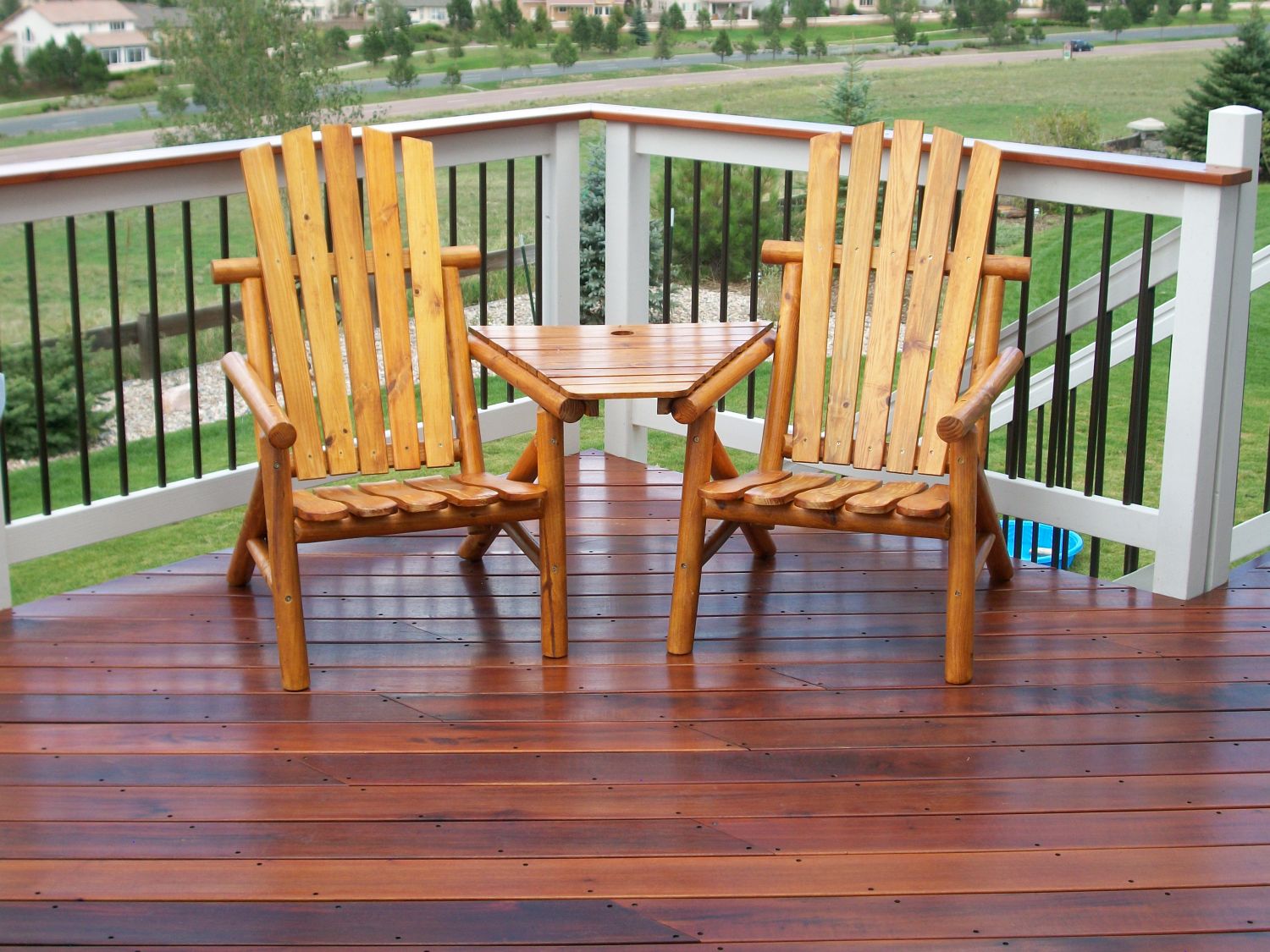 Gorgeous hardwood deck in Tigerwood with two Adirondack chairs