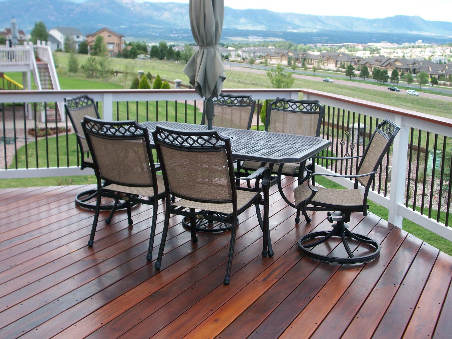 A custom built hardwood deck with a large table and chairs for entertaining.