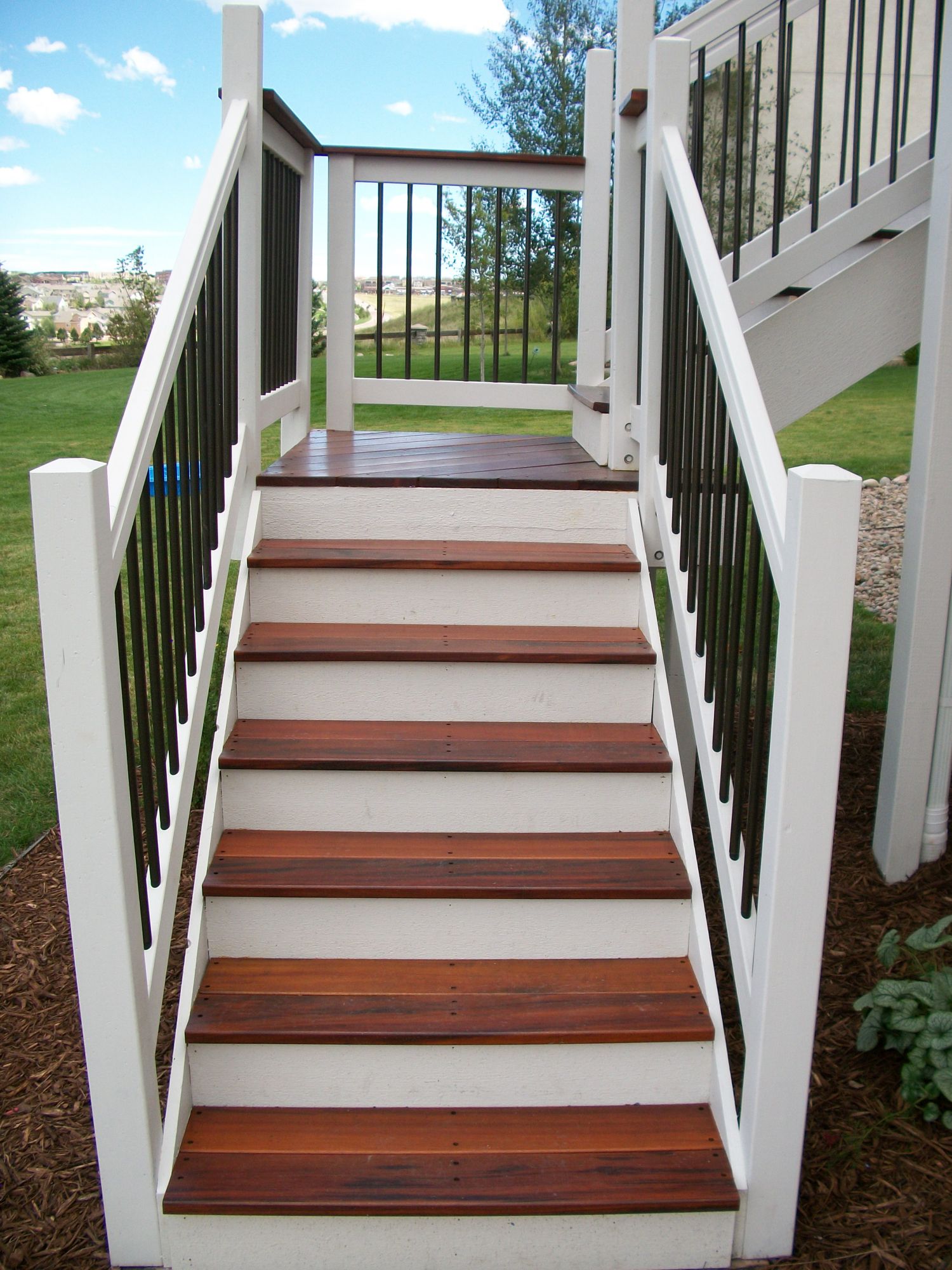 Deck stairs with hardwood treads and a 90-degree turn landing