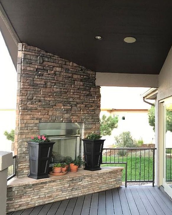 Composite deck with a stone, gas fireplace
