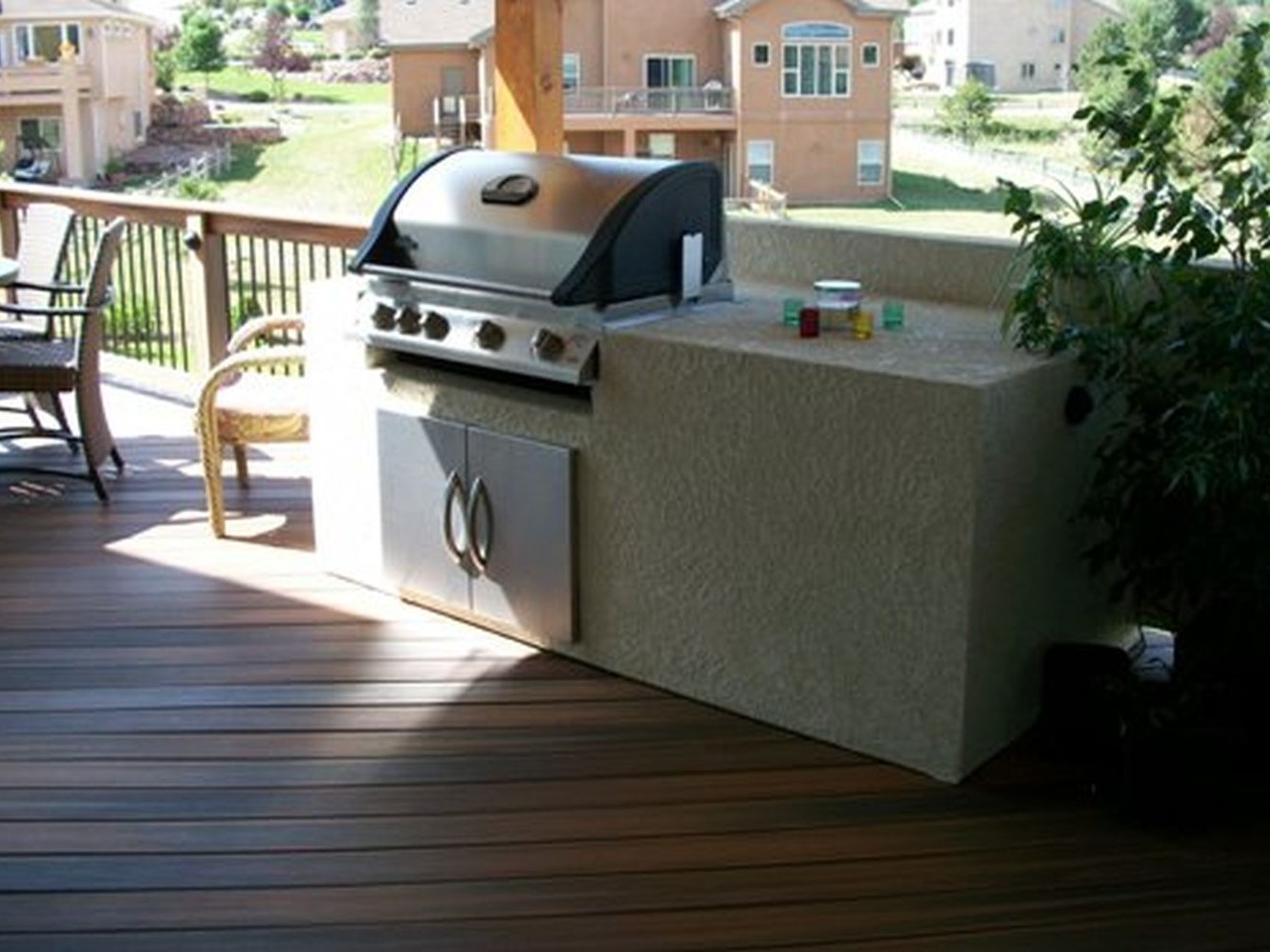 Stucco enclosed grill with preparation area and storage cabinet.