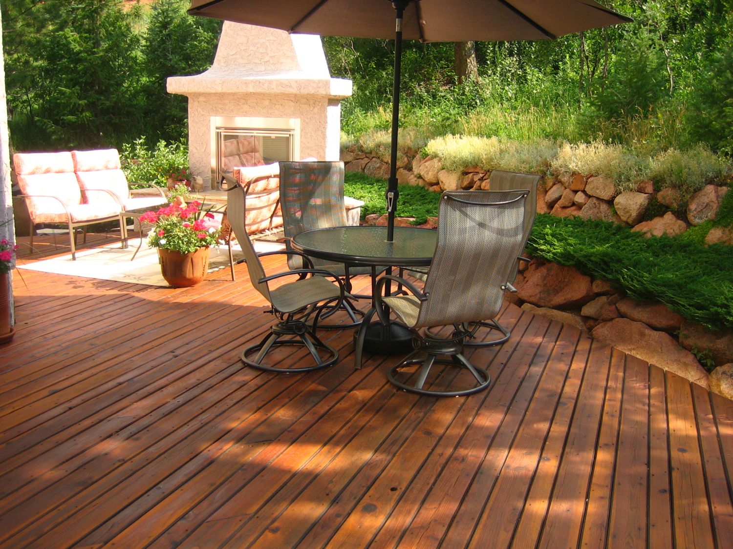 Gorgeous hardwood deck that features a custom built stucco fireplace