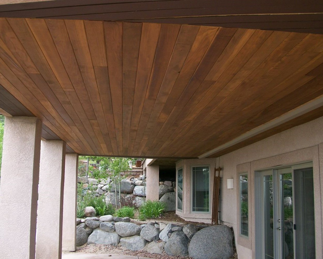 An under-deck drainage system with a redwood ceiling