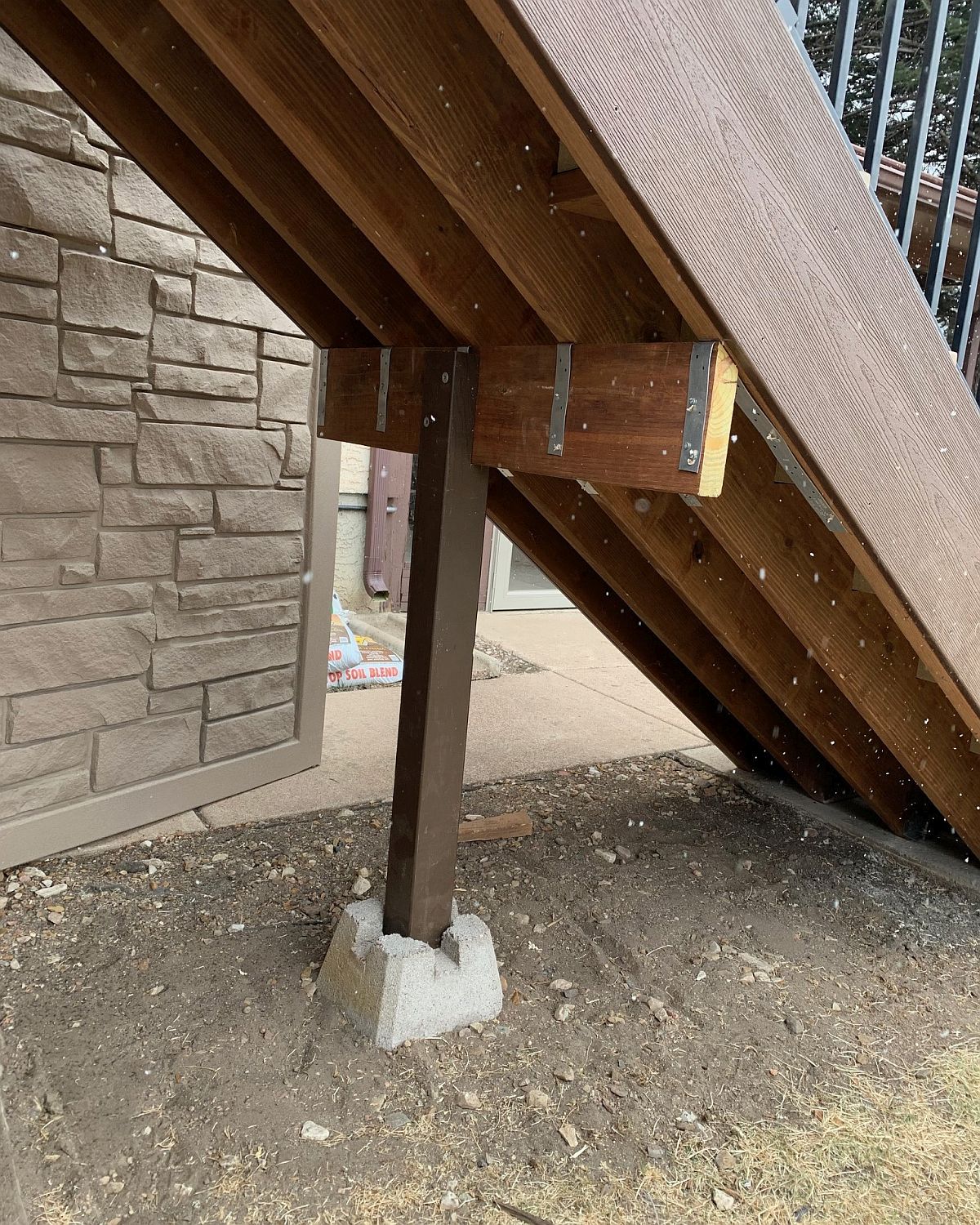 Composite deck stairs with a brace for added strength