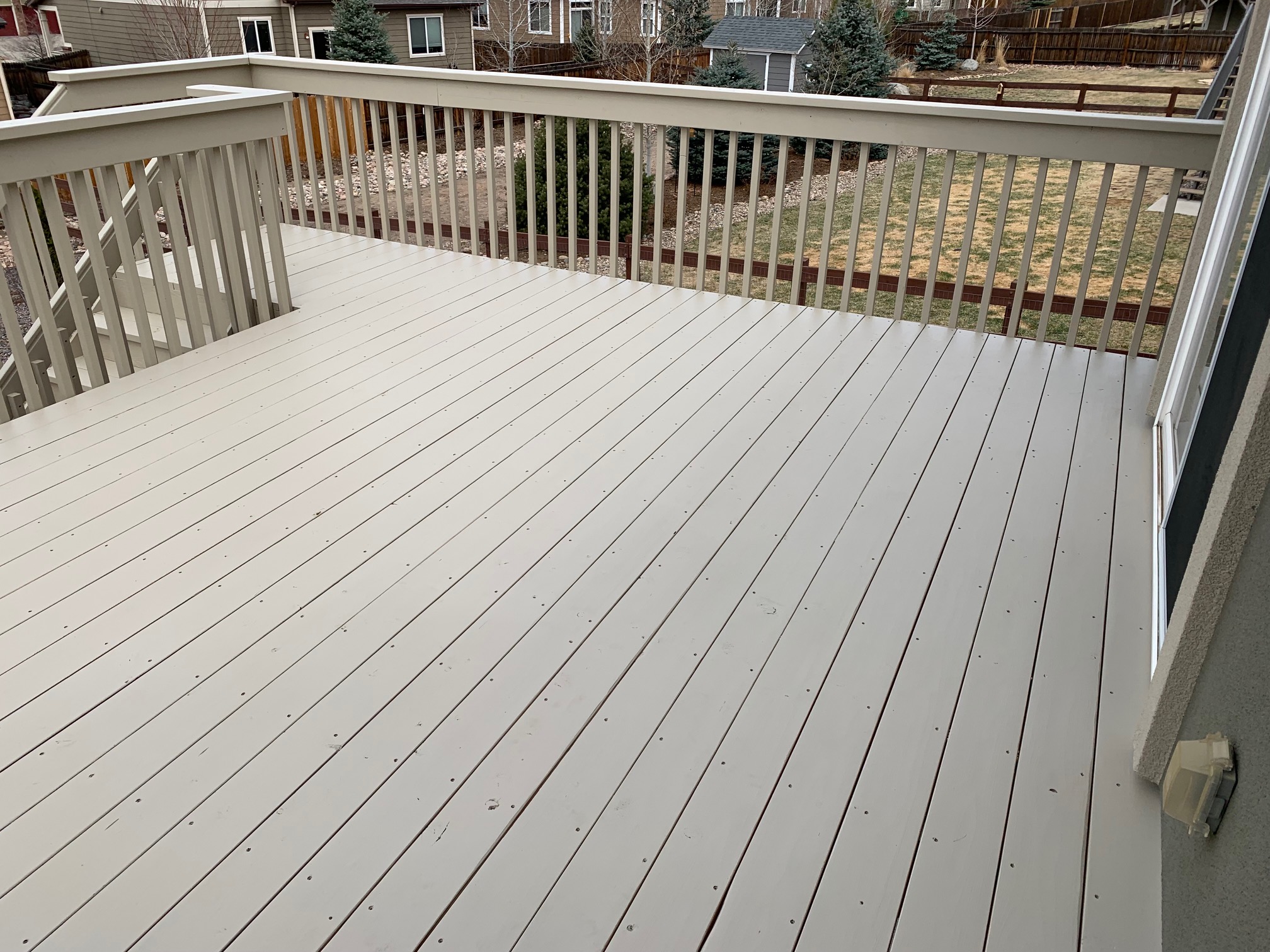Redwood deck with picket fence railing and drink cap. Stained in a solid-body stain (Kwal Johnston).