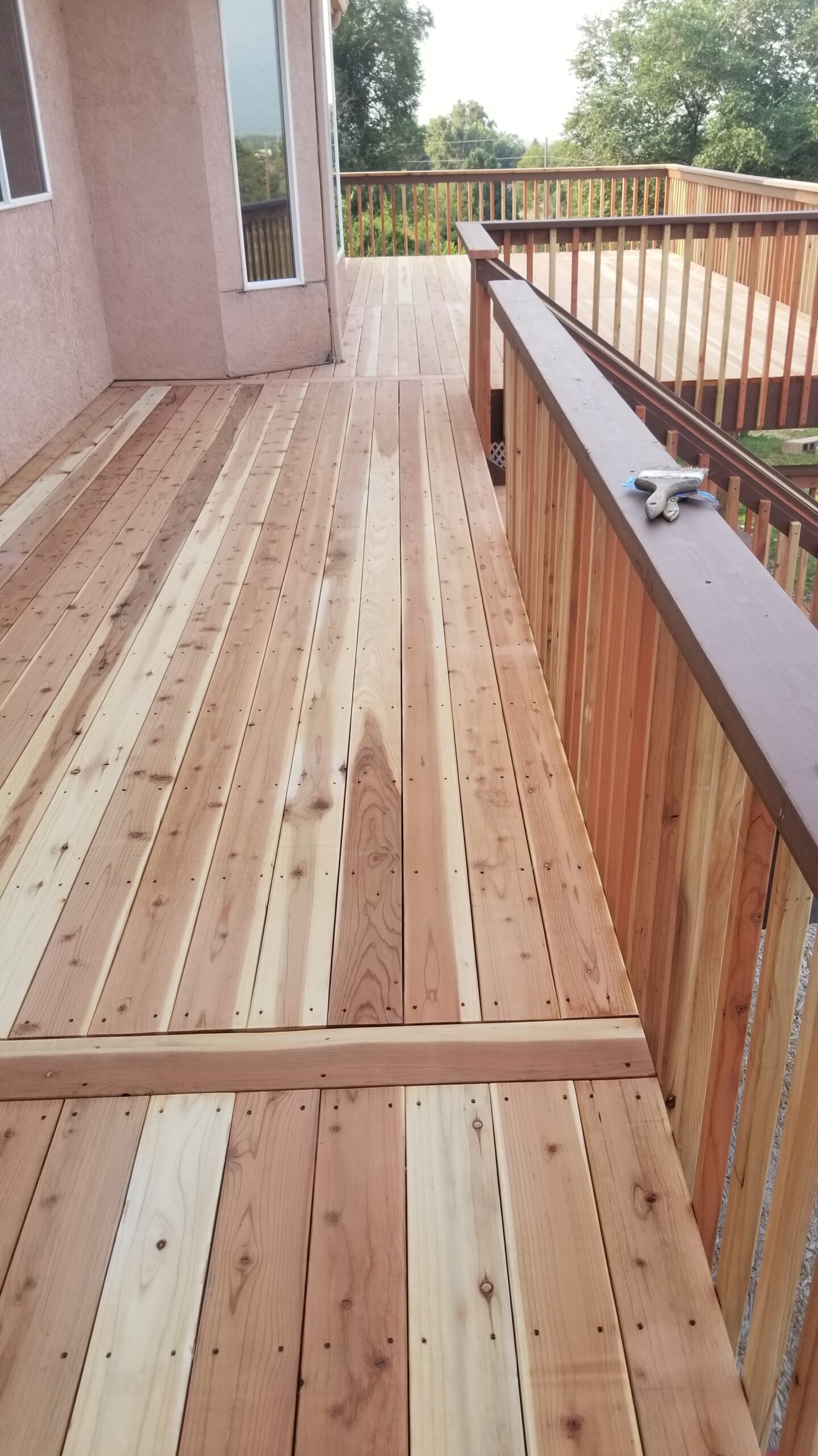Redwood deck and railing with single divider boards, before staining.