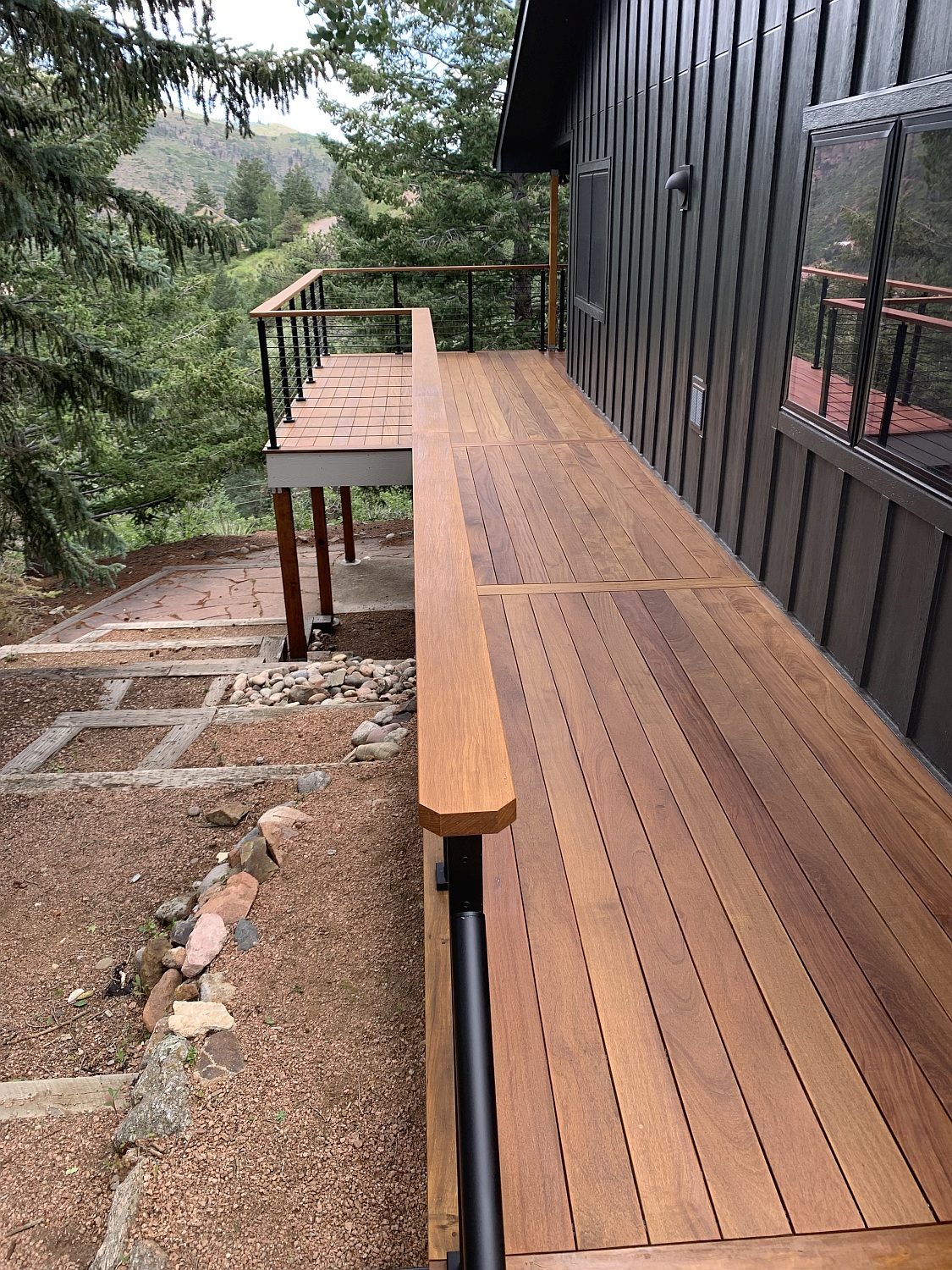 Cumaru hardwood deck with a custom metal railing topped with a Cumaru drink cap