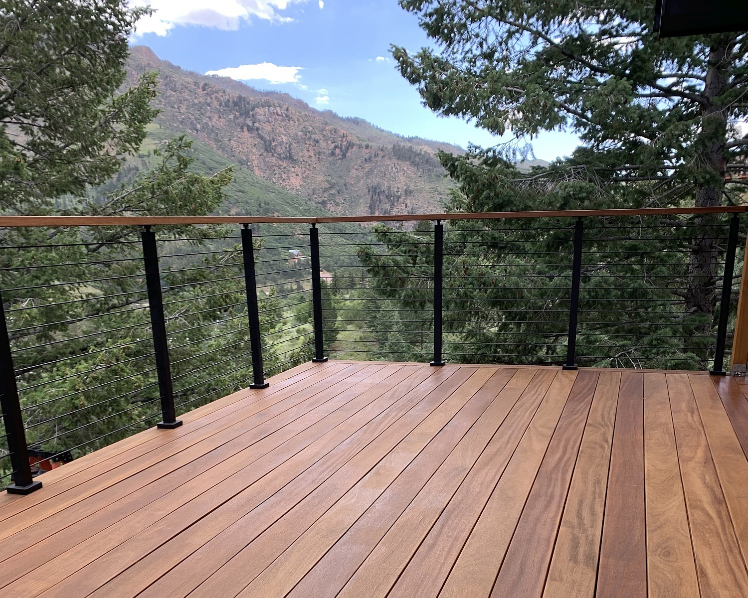 A custom designed deck built with Cumaru hardwood. It has a beautiful view of the mountains.