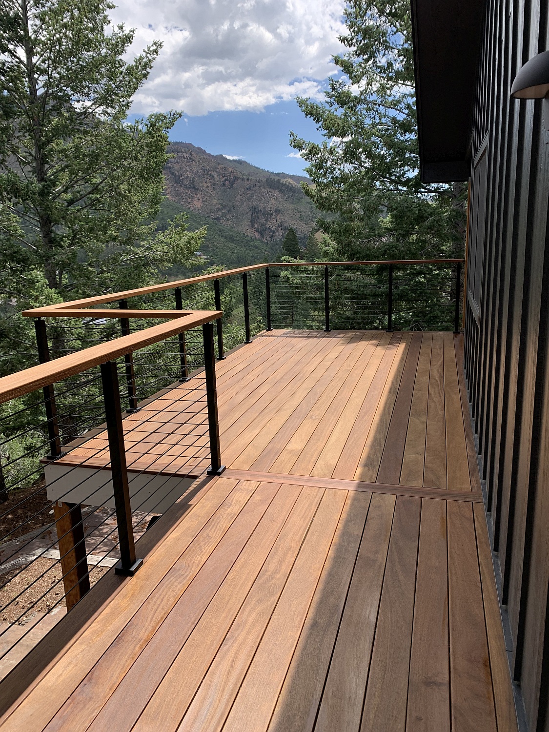 Cumaru hardwood deck with a custom metal railing system overlooking Colorado mountains