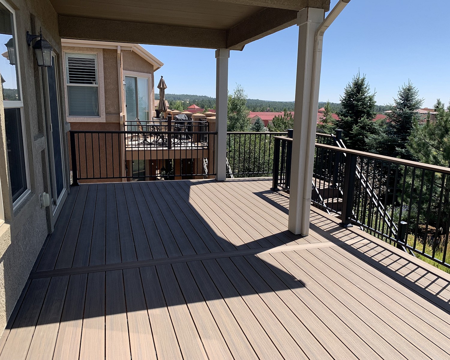 New deck built with Deckorators composite material and a Fortress metal railing. It also features a deck cover which was original to the house.