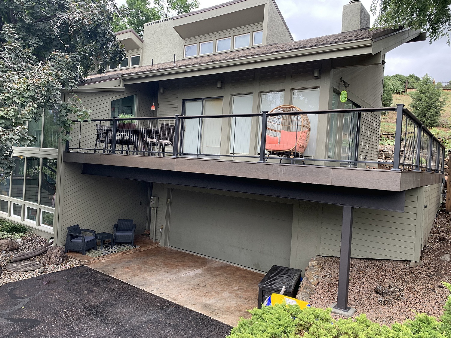 A new composite deck with a metal and cable railing creates a beautiful outdoor living space for the homeowners.