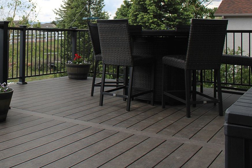 Close up of a divider board on a dark brown composite deck.