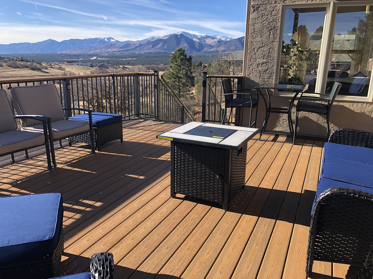 Brand new deck with a view of the mountains and a firepit surrounded by a seating area.