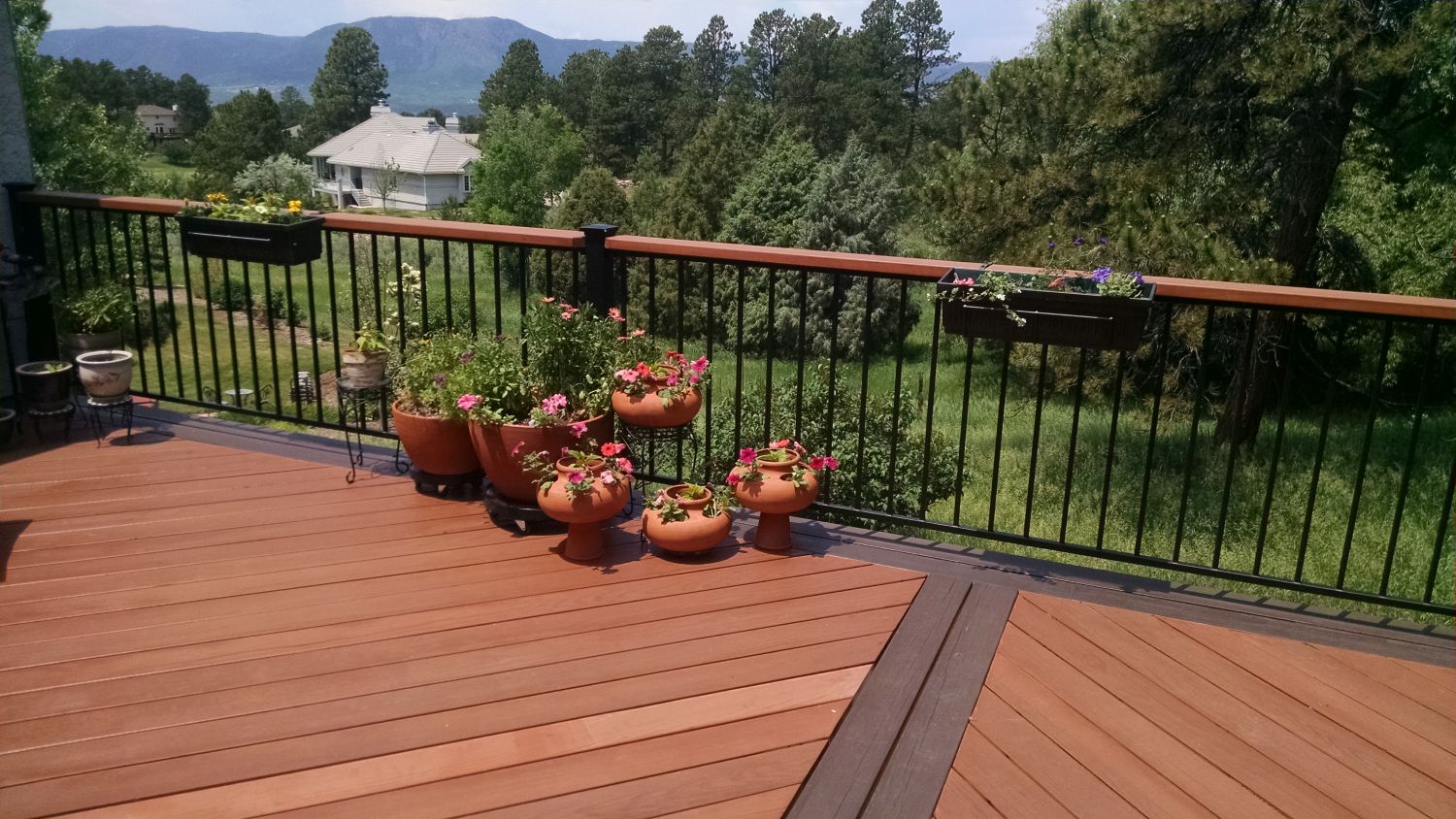Redwood deck with herringbone design and double picture frame border and dividing boards in a darker contrasting color