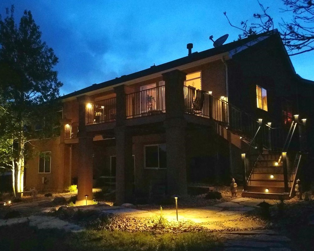The back of a home showing how the homeowners used deck lighting for safety and ambiance.